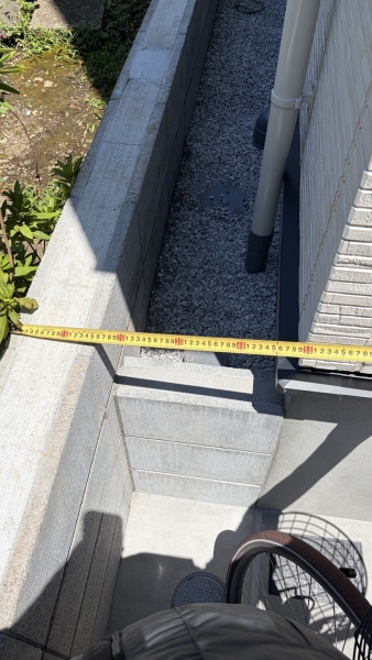 東京都豊島区の新築住宅で建物脇の作業幅を実測している状況